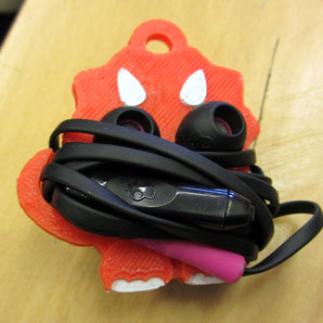 Dino Øretelefonholder
