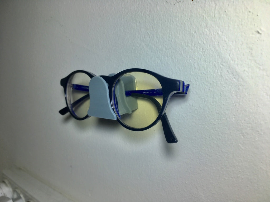 Vægmonteret holder til briller
