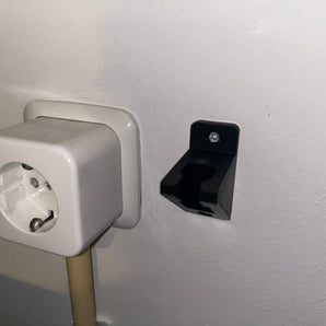 Vægmonteret strømledningsholder
